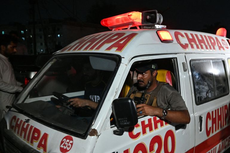 An ambulance carrying the body of a victim leaves the site after a militant attack on Pakistan's Security Rangers compound in Karachi on June 27, 2026.