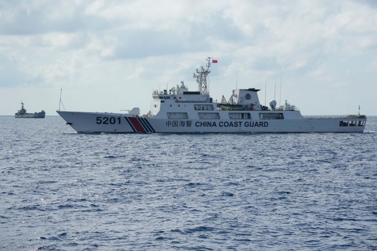 ap23117003158665-1683124895 A Chinese Coast Guard ship, right, with bow number 5201 passes by now crumbling Philippine navy ship BRP Sierra Madre, left, at the Second Thomas Shoal locally known as Ayungin Shoal at the South China Sea on Sunday, April 23, 2023. The Chinese coast guard ship blocked a Philippine patrol vessel steaming into a disputed shoal in the South China Sea in the latest act of Beijing's aggression in the strategic waterway that led to a frightening near-collision witnessed by journalists. Filipino forces have been stationed aboard the still-actively commissioned Philippine navy ship, the BRP Sierra Madre, which was deliberately marooned in the shoal in 1999 and now serves as a fragile symbol of Manila's territorial claim to the atoll. (AP Photo/Aaron Favila)