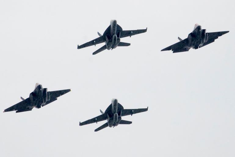 CORRECTS IDENTIFICATION OF AIRCRAFT: U.S. Navy F18 and F35 aircraft fly overhead as President Donald Trump speaks during an Independence Day celebration in front of the Lincoln Memorial, Thursday, July 4, 2019, in Washington. (AP Photo/Andrew Harnik)