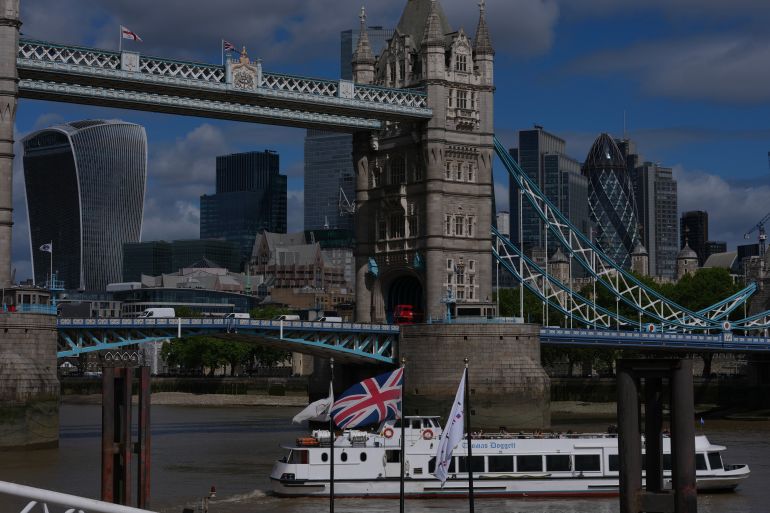A boat sails past Tower Bridge in London, Wednesday, May 20, 2026. (AP Photo/Kin Cheung)