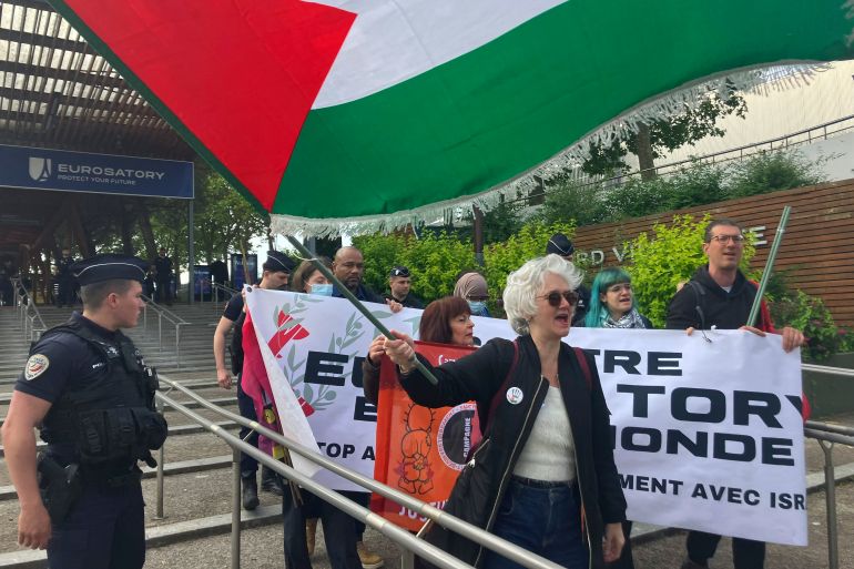 Protestors gather outside the Eurosatory exhibition, a global event for Defence and Security, in Villepinte, outside Paris, Monday, June 17, 2024. A major defense and security industry show outside Paris says a French court has banned Israeli exhibitors from participating. (AP Photo/Masha Macpherson)