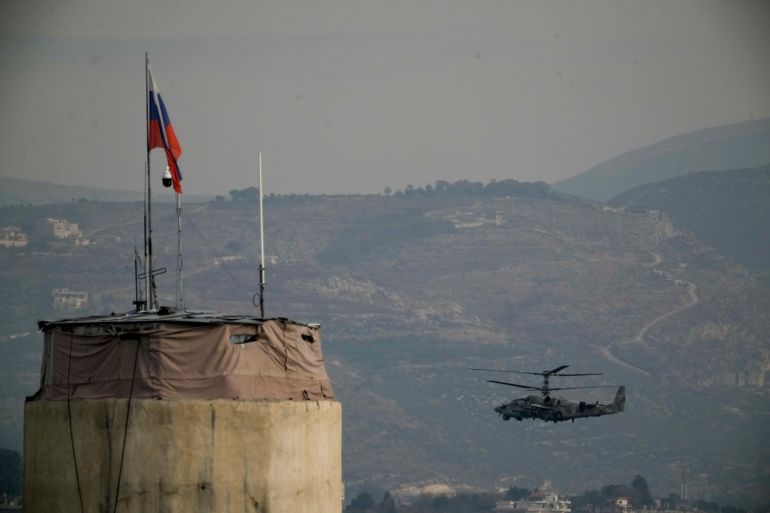 FILE - A Russian helicopter flies over the Hmeimim Air Base, a Syrian airbase currently operated by Russia, located southeast of the city of Latakia in the town of Hmeimim, Syria, on Monday, Dec.16, 2024. (AP Photo/Leo Correa, File)