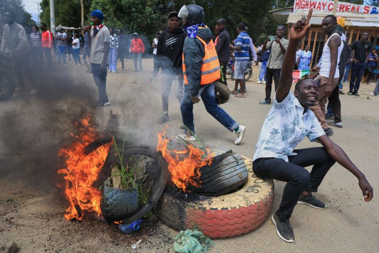 ap_6a1eaaf60a320-1780394742 A protester gestures beside a burning barricade during a demonstration against a proposed Ebola quarantine center to be established by the United States at Laikipia Air Base in Nanyuki, Kenya, Monday, June 1, 2026. (AP Photo/Andrew Kasuku)