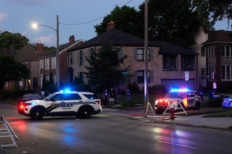 Police stand near where multiple people were shot at a community festival at the Agnes Reynolds Jackson Arboretum Saturday, June 6, 2026, in Toledo, Ohio. (AP Photo/Paul Sancya)