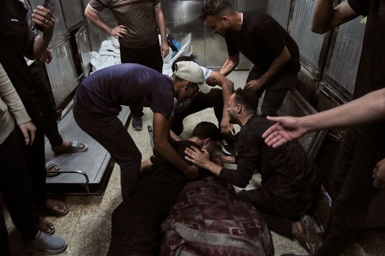 ap_6a269297119ba-1780912791 Palestinians mourn over the body of Mohammed Al-Harazin at the morgue of Shifa Hospital after he was killed in an Israeli airstrike on a vehicle in Gaza City, Sunday, June 7, 2026. (AP Photo/Jehad Alshrafi)