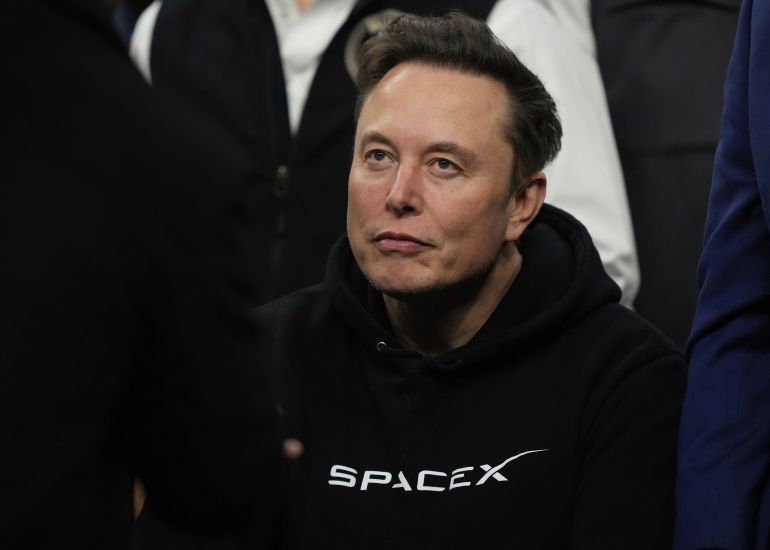 ap_6a29c29d8f8d2-1781121693 FILE - Elon Musk attends the finals for the NCAA wrestling championship, March 22, 2025, in Philadelphia. (AP Photo/Matt Rourke, File)