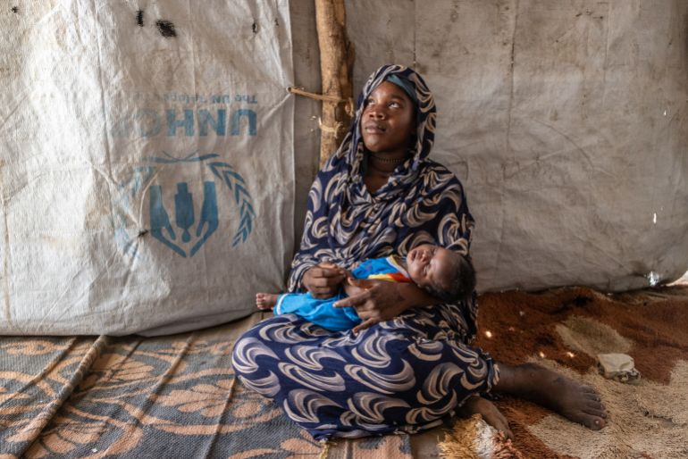 Maude Ahmad Fadala rocks her baby inside the Korsi Refugee Camp, where she gave birth in the street in Birao, Central African Republic, Thursday, March 26, 2026. (AP Photo/Caitlin Kelly)