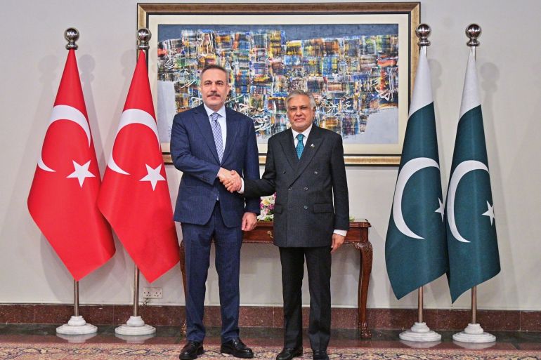 In this photo released by the Pakistan Ministry of Foreign Affairs, Turkish Foreign Minister Hakan Fidan, left, shakes hands with his Pakistani counterpart Ishaq Dar prior to their meeting in Islamabad, Pakistan, Sunday, March 29, 2026. (Pakistan Ministry of Foreign Affairs via AP)