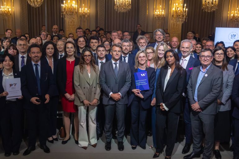 ap_6a2e3e81c190d-1781415553 French President Emmanuel Macron, centre, poses for a picture with members of the Engagement Groups involved in the G7 on social and economic issues at the Elysee Palace in Paris, France, June 10, 2026. (Christophe Petit Tesson/Pool Photo via AP)