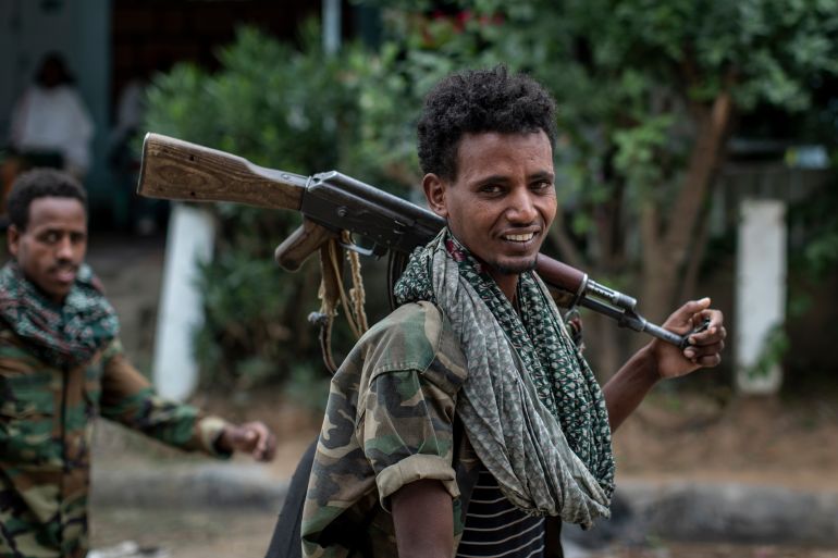 ap_6a2e4c05c1a8d-1781419013 FILE - Fighters loyal to the Tigray People's Liberation Front (TPLF) walk along a street in the town of Hawzen, then controlled by the group, in the Tigray region of northern Ethiopia, May 7, 2021. (AP Photo/Ben Curtis, File)