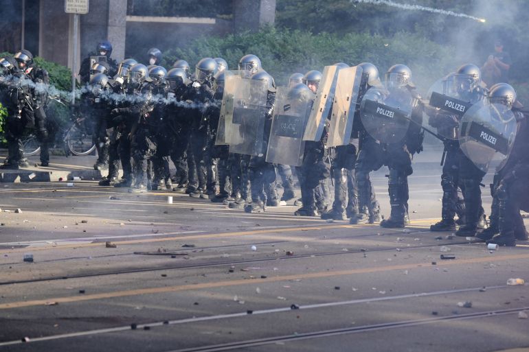 ap_6a2f9df96fb0c-1781505529 Police respond to protesters during a "No G7" demonstration in Geneva, Switzerland, Sunday, June 14, 2026, ahead of the G7 summit scheduled to take place June 15-17. (AP Photo/Baz Ratner)