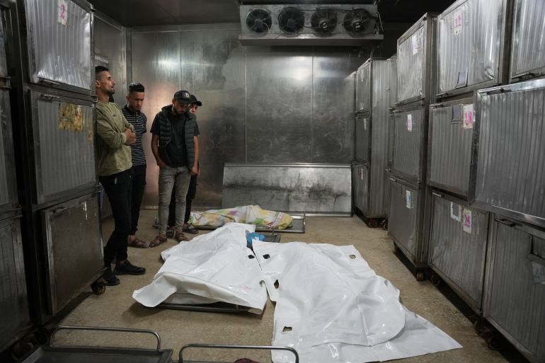 ap_6a3681c23a280-1781957058 Mourners take the last look at the bodies of two Palestinian girls Zeina Safadi, and her sister Lana, who were killed during an overnight Israeli airstrike when it damaged their home, during their funeral in Gaza city, Saturday, June 20, 2026. (AP Photo/Abdel Kareem Hana)