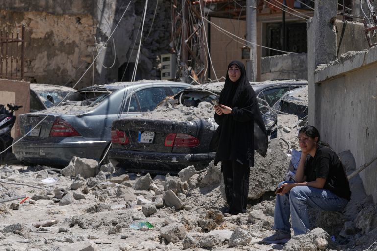 Relatives of missed victims weep, as they gather at the site of destroyed buildings that were hit in an Israeli airstrike in Qannarit village, southern Lebanon, Saturday, June 20, 2026. (AP Photo/Mohammed Zaatari)