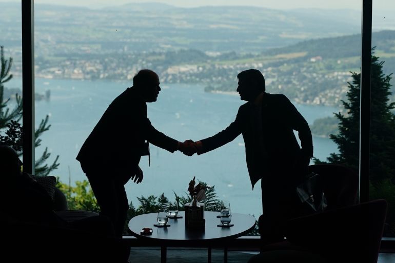Delegation staff members meet in the lobby on the first day of a quadrilateral meeting between the U.S., Iran, Pakistan, and Qatar at the Buergenstock Resort Lake Lucerne, near Stansstad, Switzerland, Sunday, June 21, 2026. (Nathan Howard/Pool Photo via AP)