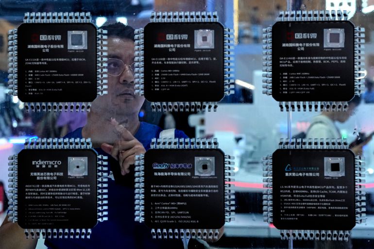 ap_6a38f6d1e3acb-1782118097 A man takes a closer look at various Chinese made chips for the automotive market showcased at the Auto China 2026, in Beijing, Saturday, April 25, 2026. (AP Photo/Andy Wong)