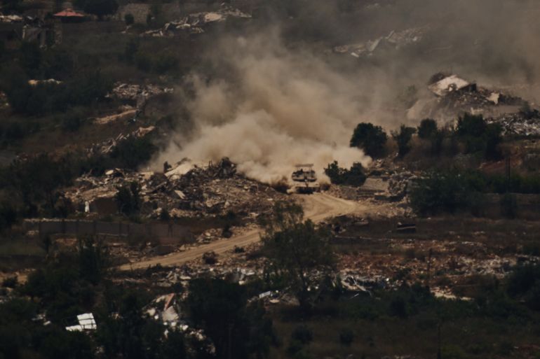 An Israeli tank moves past destroyed buildings in southern Lebanon as seen from northern Israel, Friday, June 26, 2026. (AP Photo/Leo Correa)