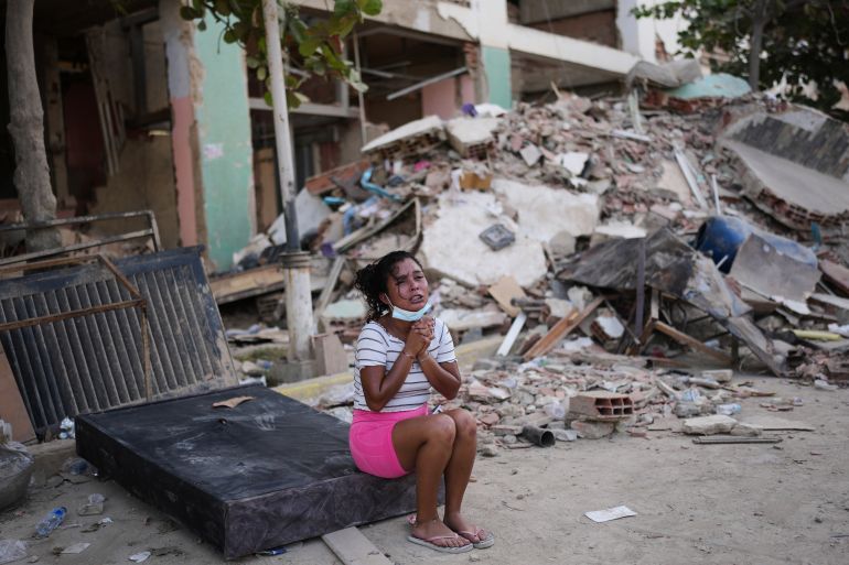 A woman cries next to damaged buildings three days after an earthquake struck in La Guaira, Venezuela, Saturday, June 27, 2026. (AP Photo/Matias Delacroix)