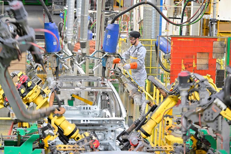 d8aad984d8aad984d8aa-2-1726656823 A worker assembles vehicle parts on a production line inside Renault factory, on the outskirts of Tangier, Morocco, Monday, April 29, 2024. Morocco has grown into a car manufacturing juggernaut over the past fifteen years, positioning itself strategically between East and West as the automotive industry transitions to electric vehicles. The country supplies more cars to Europe than China, India or Japan through new highways and an expanded port in Tangier. (AP Photo)