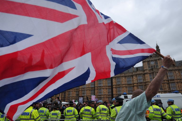 d9a2d9a2d9a2d9a2-1718735673 A British National Party (BNP) supporter waves a Union flag during a march in central London on June 1, 2013. AFP PHOTO / CARL COURT (Photo by CARL COURT / AFP)