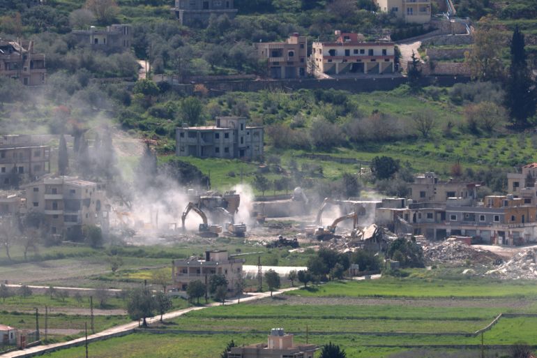 epa12887475 Israeli army excavators demolish buildings in the southern Lebanese village of Mais al-Jabal, as seen from the Israeli side of the border, 13 April 2026. The Israeli military stated it is conducting operations in southern Lebanon targeting Hezbollah infrastructure and personnel. EPA/ATEF SAFADI