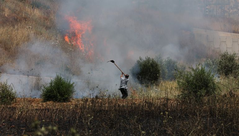 epa13020274 A Palestinian man tries to extinguish smouldering farms following an attack by Israeli settlers in the village of Huwwara, near Nablus, in the West Bank, 06 June 2026. According to Wafa Agency, nine Palestinians were injured on Saturday during an attack carried out by Israeli settlers on the town of Huwwara, south of Nablus. EPA/ALAA BADARNEH