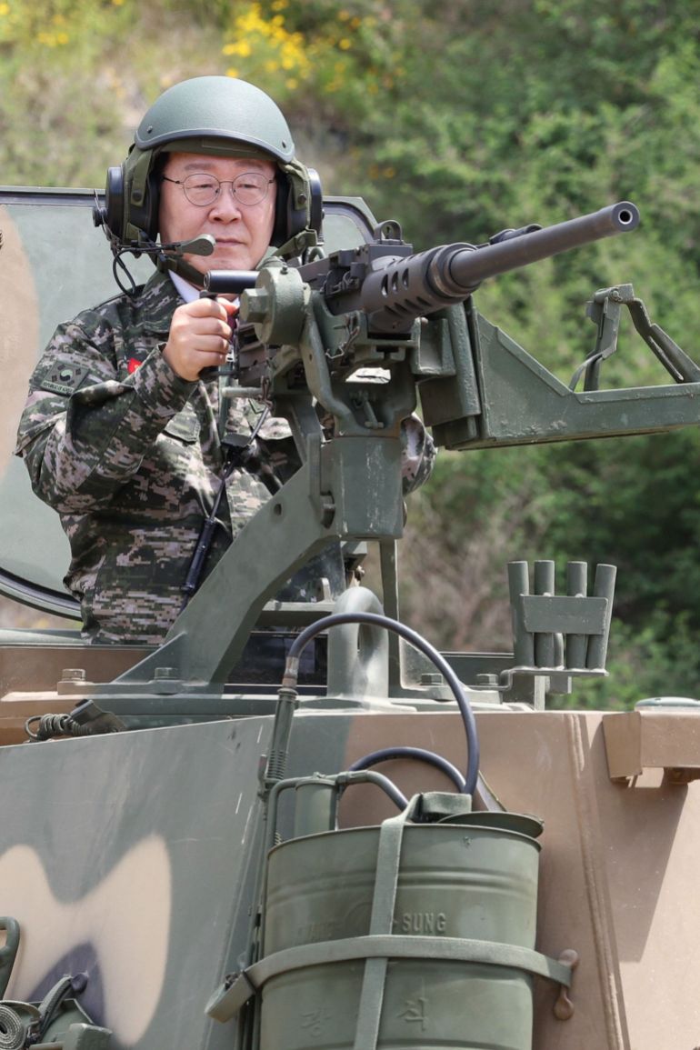 epa13060095 South Korean President Lee Jae Myung takes aim with a K-6 heavy machine gun while riding in a K9A1 self-propelled howitzer during a visit to a Marine Corps unit on Yeonpyeong Island near the Northern Limit Line, the de facto sea border with North Korea in the Yellow Sea, in South Korea, 24 June 2026, to mark the 76th anniversary the next day of the outbreak of the 1950-53 Korean War. EPA/YONHAP / POOL SOUTH KOREA OUT