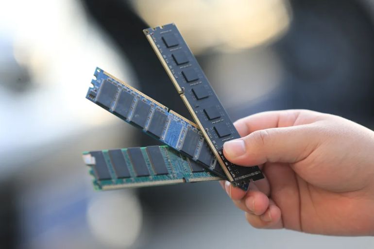 ZHENGZHOU, CHINA - JUNE 04: A staff member at a computer parts shop displays recycled memory modules on June 4, 2026 in Zhengzhou, Henan Province of China. According to TrendForce's latest memory spot price trend report, in terms of DRAM, DDR4 and DDR5 spot prices continued to rise, with both segments posting notable gains. (Photo by VCG/VCG via Getty Images)