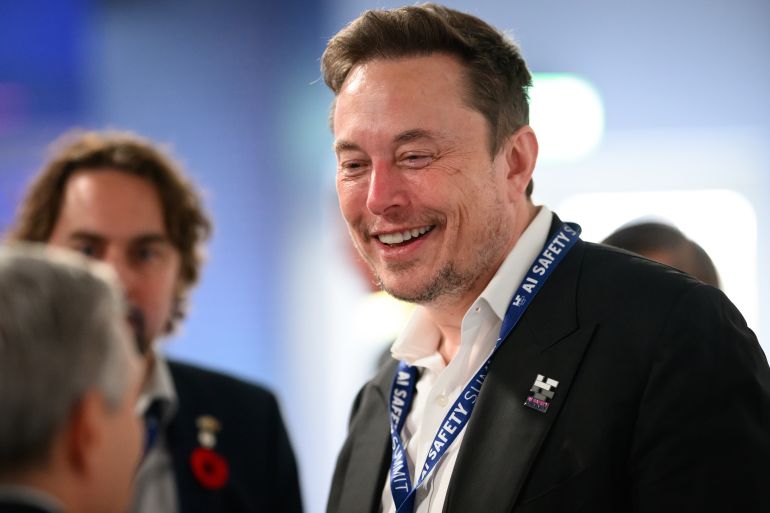 getty_6a100cfc19-1779436796 BLETCHLEY, ENGLAND - NOVEMBER 01: SpaceX, X (formerly known as Twitter), and Tesla CEO Elon Musk speaks with other delegates during day one of the AI Safety Summit at Bletchley Park on November 01, 2023 in Bletchley, England. The UK Government are hosting the AI Safety Summit bringing together international governments, leading AI companies, civil society groups and experts in research to consider the risks of AI, especially at the frontier of development, and discuss how they can be mitigated through internationally coordinated action. (Photo by Leon Neal/Getty Images)