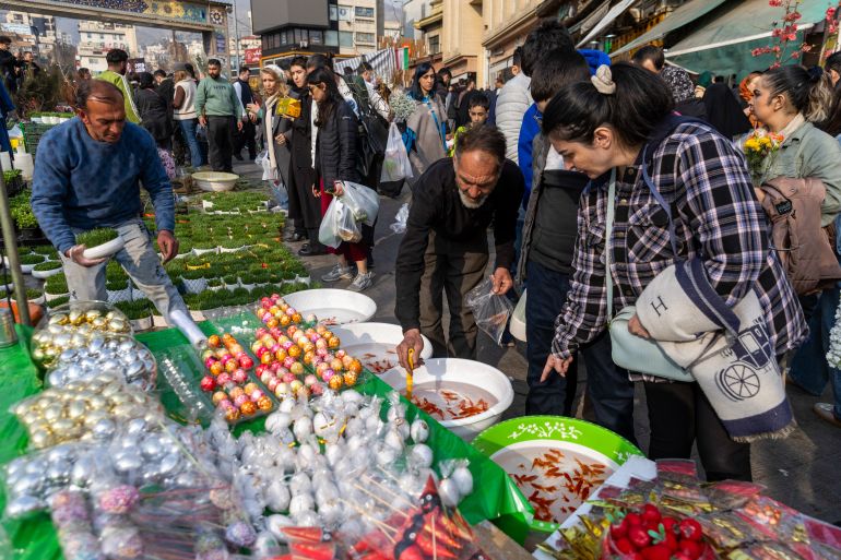 TEHRAN, IRAN - MARCH 19: People shop for goldfish at a market ahead of Nowruz celebrations on March 19, 2026 in Tehran, Iran. Nowruz, or Persian New Year, is a festival celebrated worldwide by various ethnicities. It takes place on the spring equinox, according to the Iranian Solar Hijri calendar. This year the holiday falls three weeks into the war that broke out on February 28 with US-Israeli joint attacks on Iran, which killed Supreme Leader Ayatollah Ali Khamenei. Iran has retaliated by firing waves of missiles and drones at Israel, and targeting U.S. allies in the region. (Photo by Majid Saeedi/Getty Images)