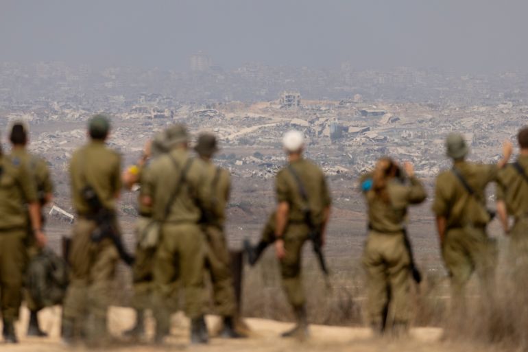 getty_6a1bc78550-1780205445 SOUTHERN ISRAEL, ISRAEL - AUGUST 13: Israeli soldiers look at destructed buildings in the Northern Gaza Strip as they are standing at a view point on the Israeli side of the border on August 13, 2025 in Southern Israel, Israel. Last week Israel's security cabinet approved Prime Minister Benjamin Netanyahu's proposal to expand IDF occupation of the Gaza Strip, including taking "complete control" of Gaza City. The planned offensive has been met with widespread condemnation by the international community, as well as hostage families, who say the move would further endanger hostages still believed to be held alive by Hamas in Gaza, as well as one million Palestinians in Gaza City, who are already facing displacement and an acute hunger crisis. (Photo by Amir Levy/Getty Images)