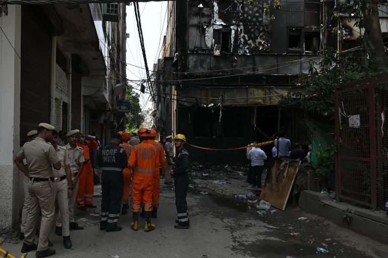 getty_6a203c1819-1780497432 NEW DELHI, INDIA - JUNE 03: Rescue workers and forensic department personnel gather inside a building following a fire at a restaurant on June 03, 2026 in New Delhi, India. The blaze, which broke out in the early hours, spread rapidly through the densely packed structure before firefighters were able to bring it under control, authorities said. (Photo by Ritesh Shukla/Getty Images)
