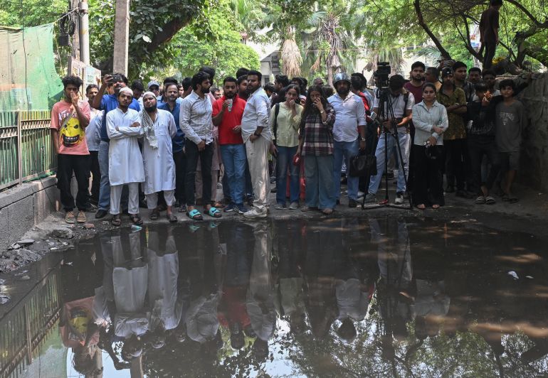 getty_6a203c3bce-1780497467 NEW DELHI, INDIA - JUNE 03: Local residents gather outside a building following a fire at a restaurant on June 03, 2026 in New Delhi, India. The blaze, which broke out in the early hours, spread rapidly through the densely packed structure before firefighters were able to bring it under control, authorities said. (Photo by Ritesh Shukla/Getty Images)