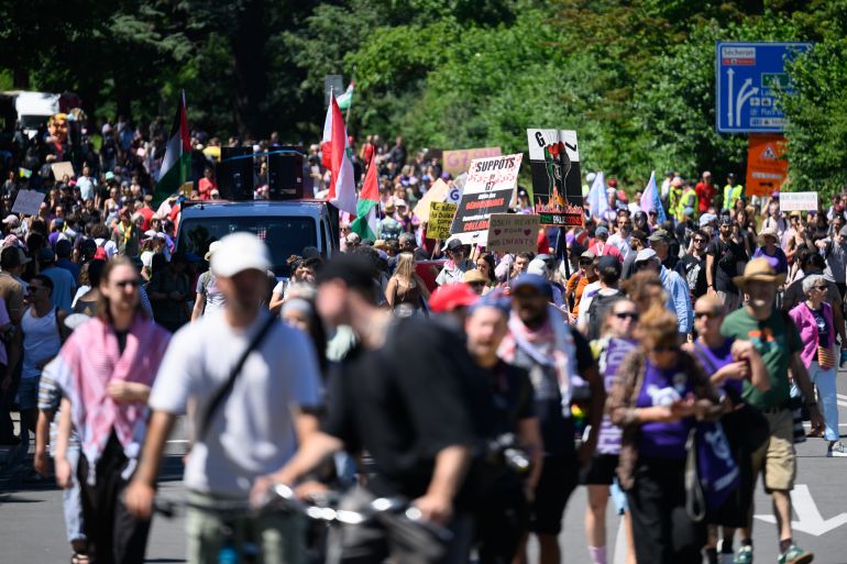 getty_6a2fadc821-1781509576 GENEVA, SWITZERLAND - JUNE 14: People gather during a protest ahead of the G7 Summit on June 14, 2026 in Geneva, Switzerland. This week's G7 summit will take place from June 15-17 in nearby Evian-les-Bains, France, as leaders grapple with challenges to peace and security for Ukraine and Europe, the situation in the Middle East, and other geopolitical issues. (Photo by Harold Cunningham/Getty Images)