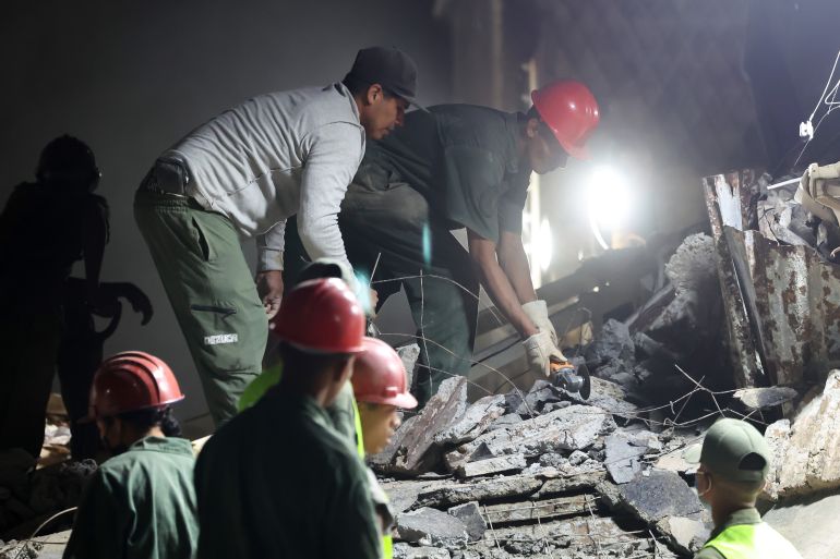 CARACAS, VENEZUELA - JUNE 24: People and rescuers work on the debris of a damaged building after a magnitude 7.2 earthquake struck Venezuela and other regions in the Caribbean on June 24, 2026, in Caracas, Venezuela. According to the U.S. Geological Survey (USGS), the main earthquake was followed by a 7.5-magnitude aftershock less than a minute later; although some buildings collapsed, the number of victims, according to the authorities, is 32, and over 700 have been injured. (Photo by Edilzon Gamez/Getty Images)