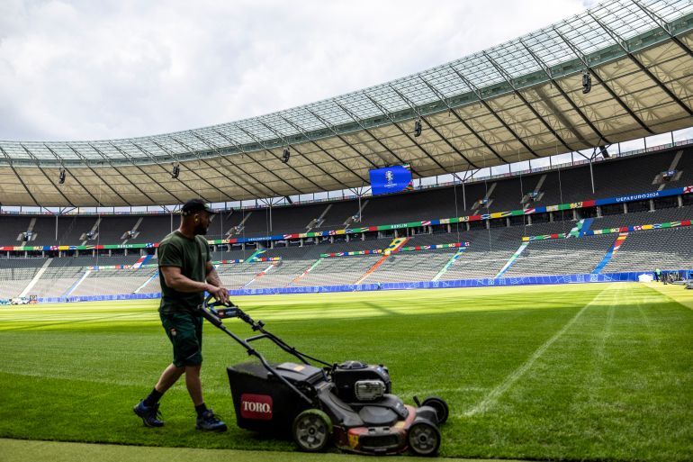 BERLIN, GERMANY - JUNE 07: A grass keeper prepares the pitch a Olympiastadion Berlin ahead of the UEFA EURO 2024 Germany at Olympiastadion on June 07, 2024 in Berlin, Germany. Germany is hosting the Euro 2024, which will begin on June 14. (Photo by Maja Hitij/Getty Images)