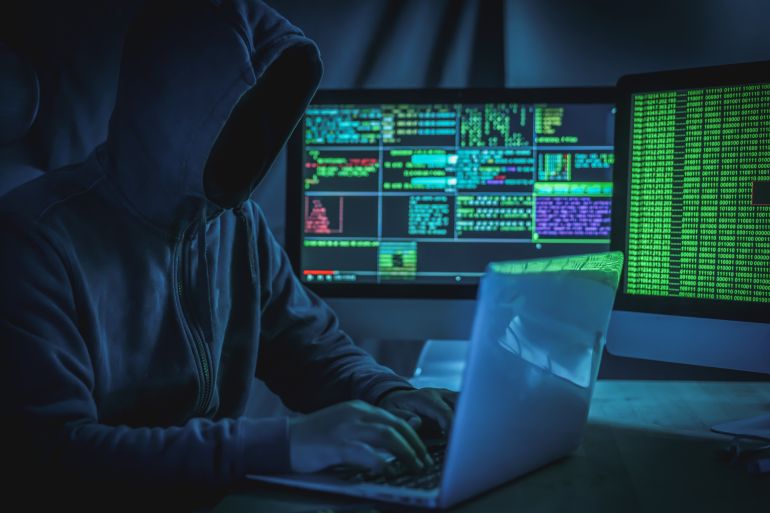 gettyimages-1873955569-1736159041 Wanted hackers coding virus ransomware using laptops and computers.