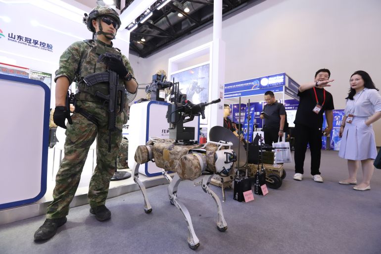 gettyimages-2153544064-1718968835 BEIJING, CHINA - MAY 17: Visitors view a fighting robot dog during the 9th China (Beijing) Military Intelligent Technology Expo at the China National Convention Center on May 17, 2024 in Beijing, China. (Photo by Guo Haipeng/VCG via Getty Images)
