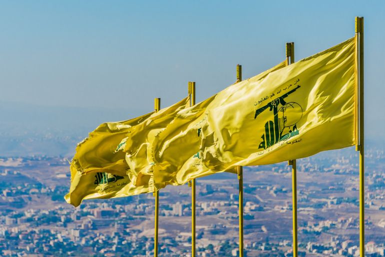 hezbollah-1781003000 MLEETA - SEPTEMBER 26: Hezbollah flags over southern Lebanese land. The Arabic text reads "Then surely the party of Allah are they that shall be triumphant" and "The Islamic Resistance in Lebanon."