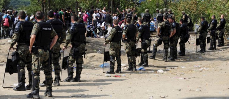 immigration-to3-1779190851 Macedonian special policemen guard the border as more than a thousand immigrants wait at the border line of Macedonia and Greece to enter Macedonia near the Gevgelija railway station August 21, 2015. Macedonian police drove back crowds of migrants and refugees trying to enter from Greece on Friday after a night spent stranded in no-man's land by an emergency decree effectively sealing the Macedonian frontier. REUTERS/Ognen Teofilovski