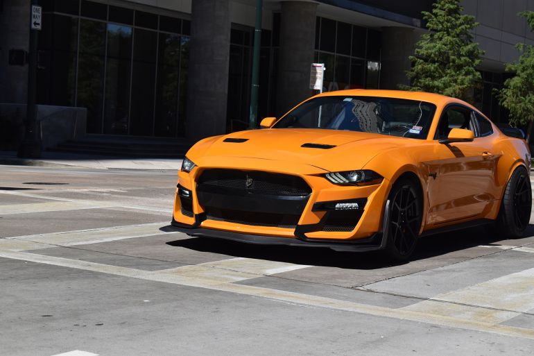 jet-2-1777297806 Houston, TX USA 9-28-2024 - An orange Ford Mustang Shelby GT500 (with a Carbon Fiber Track Pack) cruising in the downtown financial district.; Shutterstock ID 2524440195; purchase_order: aj; job: ; client: ; other: