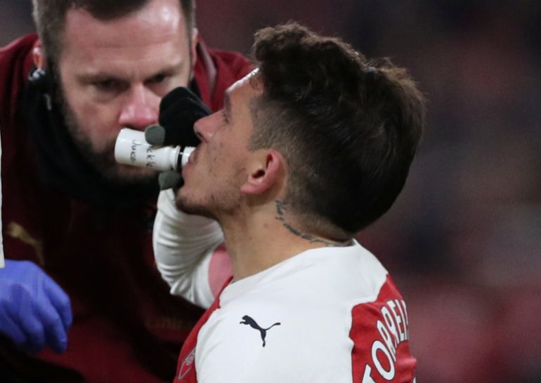 Soccer Football - Premier League - Arsenal v Chelsea - Emirates Stadium, London, Britain - January 19, 2019 Arsenal's Lucas Torreira drinks from a bottle labelled "pickle juice" during the match REUTERS/Hannah Mckay EDITORIAL USE ONLY. No use with unauthorized audio, video, data, fixture lists, club/league logos or "live" services. Online in-match use limited to 75 images, no video emulation. No use in betting, games or single club/league/player publications. Please contact your account representative for further details.