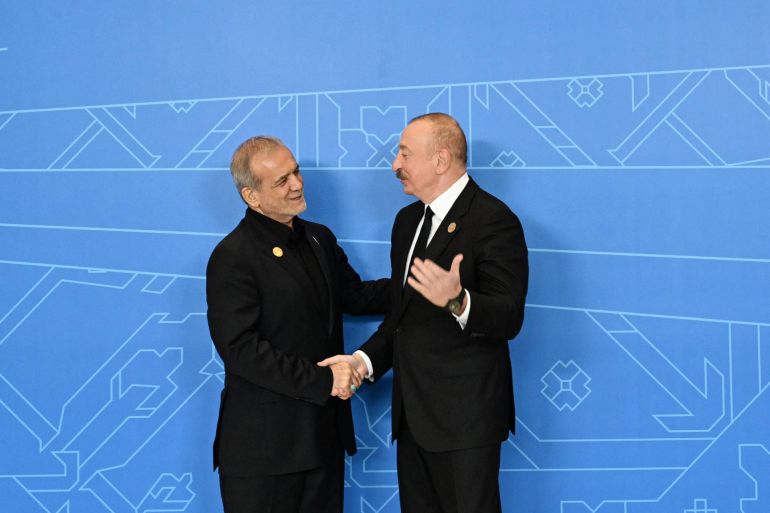 pezeshkian1-1751636187 This handout photograph released by the Azerbaijani presidential press service on July 4, 2025, shows Azerbaijani President Ilham Aliyev and Iranian President Masoud Pezeshkian shaking hands during the 17th Summit of the Economic Cooperation Organization in Khankendi, Azerbaijan. (Photo by Handout / Azerbaijani presidency / AFP) / RESTRICTED TO EDITORIAL USE - MANDATORY CREDIT "AFP PHOTO / AZERBAIJANI PRESIDENCY / HANDOUT / - NO MARKETING NO ADVERTISING CAMPAIGNS - DISTRIBUTED AS A SERVICE TO CLIENTS