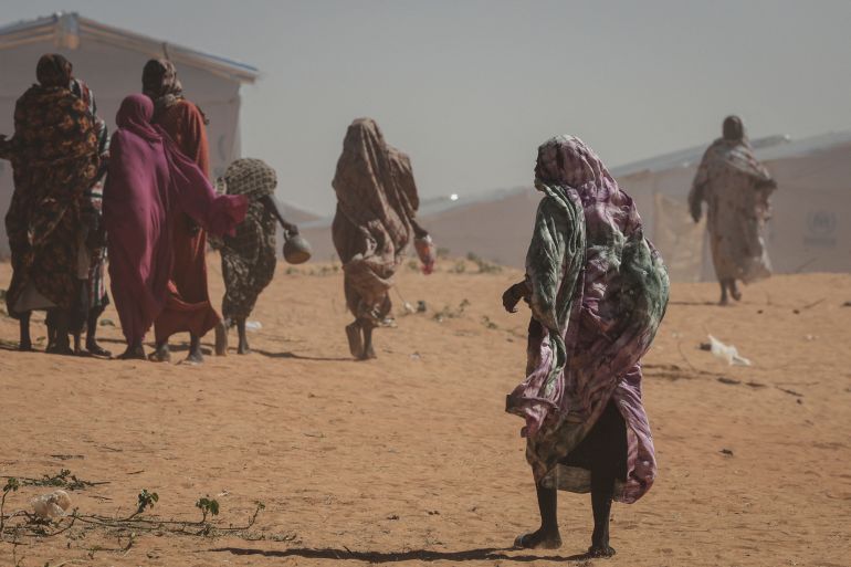 Sudanese refugee women walk at the Tulum refugee camp, amid ongoing conflict in Sudan between the paramilitary Rapid Support Forces (RSF) and the Sudanese army, in Wadi Fira province, eastern Chad, November 30, 2025. REUTERS/Amr Abdallah Dalsh SEARCH "ABDALLAH DALSH SUDAN SURVIVORS" FOR THIS STORY. SEARCH "WIDER IMAGE" FOR ALL STORIES.
