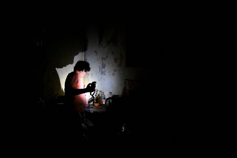 A man uses a flashlight during a blackout as Cuba's national electric grid collapsed, according to the country's grid operator, leaving around 10 million people without power amid a U.S.-imposed oil blockade, in Havana, Cuba March 16, 2026. REUTERS/Norlys Perez TPX IMAGES OF THE DAY