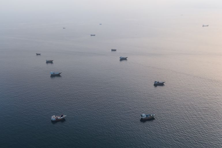 This aerial photograph shows boats anchored off Omans northern Musandam Peninsula near the Strait of Hormuz on June 27, 2026. Iran launched attacks on US sites in the Gulf in response to American strikes on the country, state media said on June 27, after Washington accused Tehran of attacking one of its cargo ships in the Strait of Hormuz. The trading of fire raised questions about efforts to keep the crucial waterway open while Washington and Tehran negotiate a final settlement to a war that began on February 28 with US and Israeli strikes on Iran. (Photo by AFP) /