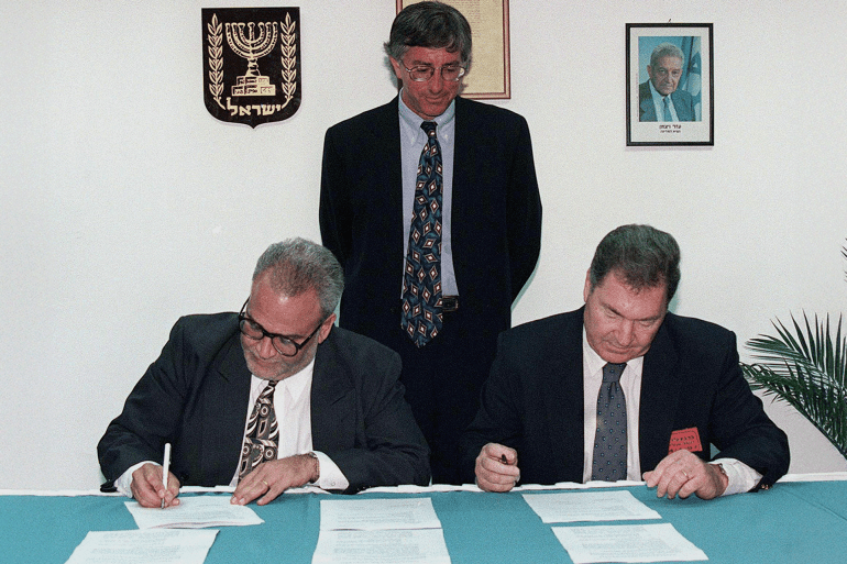 صائب عريقات United States' special envoy Dennis Ross looks on as Saeb Erekat (L), the chief Palestinian negotiator, and Dan Shomron, the chief Israeli negotiator, initial the documents that bring to a conclusion the long-delayed and overdue Israeli troop redeployment in the West Bank city of Hebron. Palestinian President Arafat and Israeli Prime Minister Netanyahu shook hands on the deal, and now both sides will take the agreement to their respective cabinets for approval. The troop redeployment will take place within ten days. MIDEAST