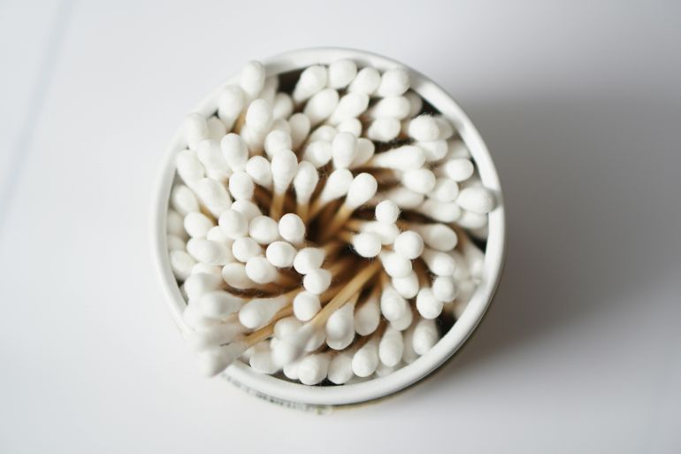 Top view of cotton buds stacked in a container, emphasizing hygiene and healthcare.