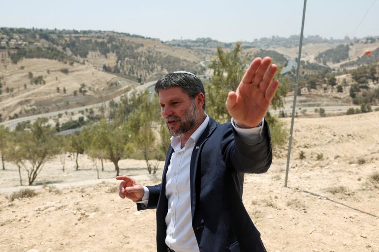 reuters_68cb018f-1758134671 FILE PHOTO: Israeli Finance Minister Bezalel Smotrich gestures, on the day of a press conference regarding settlements expansion for the long-frozen E1 settlement, that would split East Jerusalem from the occupied West Bank, near the Israeli settlement of Maale Adumim in the Israeli-occupied West Bank, August 14, 2025. REUTERS/Ronen Zvulun/File Photo