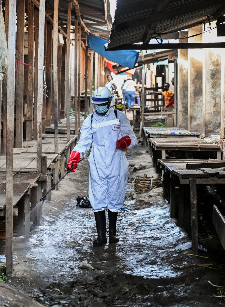 reuters_6a12a138-1779605816 A sanitation worker from the Bunia city government sprays chlorine at the central market to limit the risk of the spread of the Ebola virus, as authorities intensify efforts to contain a new Ebola outbreak involving the Bundibugyo strain, in Bunia, Ituri province, Democratic Republic of Congo, May 23, 2026. REUTERS/Stringer