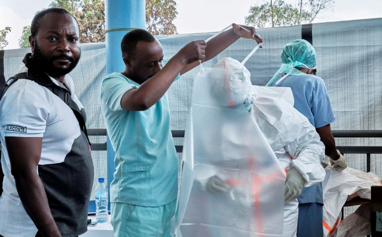 FILE PHOTO: Medical team from the Alliance for International Medical Action (ALIMA), an international NGO dress up in personal protective equipment (PPE) as they set up a treatment centre for the Ebola response, as agencies intensify efforts to contain a new Ebola outbreak caused by the Bundibugyo virus strain, in Rwampara outside Bunia, Ituri province, Democratic Republic of Congo, May 29, 2026. REUTERS/Gradel Muyisa Mumbere/File Photo